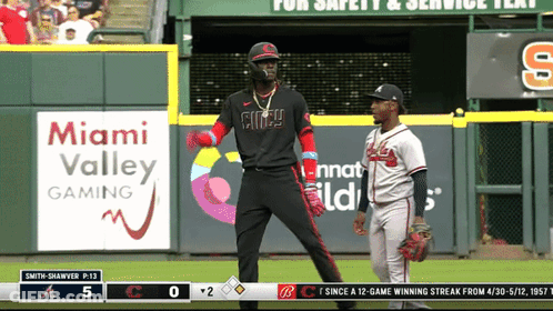 A Baseball Game Is Being Played In Front Of An Advertisement For Miami Valley Gaming GIF