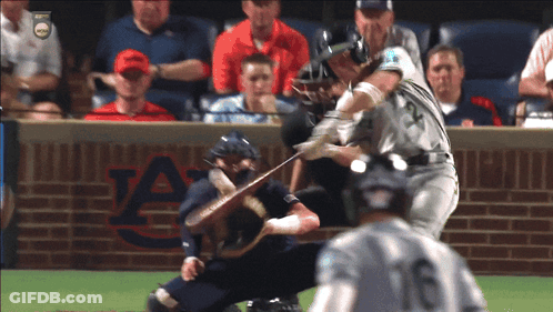 A Baseball Game Is Being Played In Front Of An Auburn Brick Wall GIF
