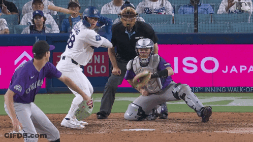 A Baseball Game Is Being Played In Front Of An Iso Japan Banner GIF