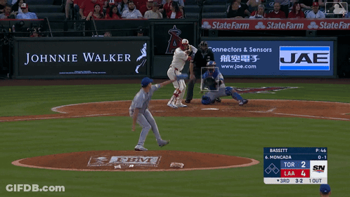 A Baseball Game Is Being Played With An Ad For Johnnie Walker GIF