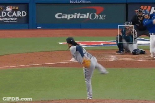 A Baseball Pitcher Is About To Throw A Ball In Front Of A Capital One Sign GIF