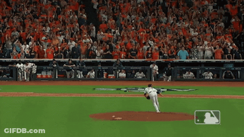 A Baseball Pitcher Is About To Throw The Ball In Front Of A Crowd That Is Cheering GIF