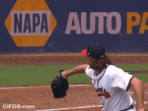A Baseball Pitcher Throws A Ball In Front Of A Napa Auto Sign GIF