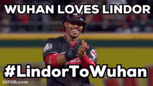 A Baseball Player Applauds While Wearing A Helmet On A Baseball Field GIF
