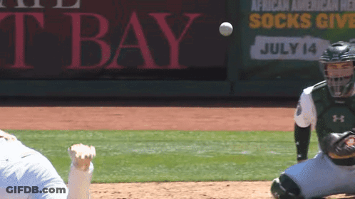 A Baseball Player Catches A Ball In Front Of A Sign That Says African American Relief Socks Give July 14 GIF
