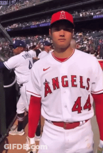 A Baseball Player For The Angels Is Standing In The Dugout GIF