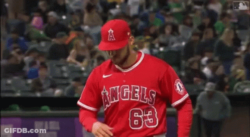 A Baseball Player For The Angels Is Standing On The Field . GIF