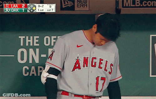 A Baseball Player For The Angels Looks Down At Something GIF
