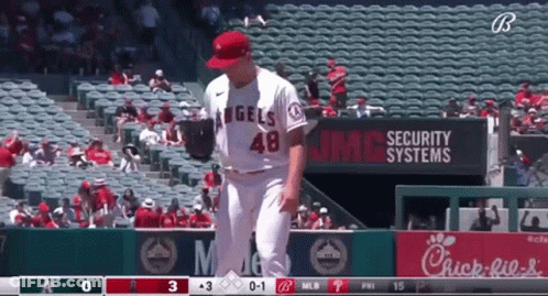 A Baseball Player For The Angels Stands In Front Of A Chick-Fil-A Sign GIF