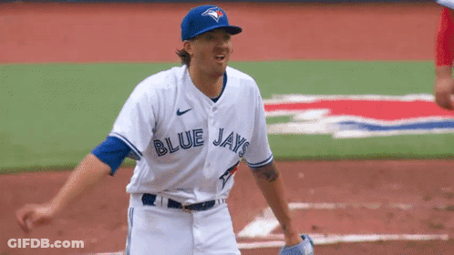 A Baseball Player For The Blue Jays Is Standing On A Field GIF