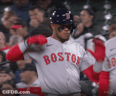 A Baseball Player For The Boston Red Sox Is Wearing A Helmet And Sunglasses GIF