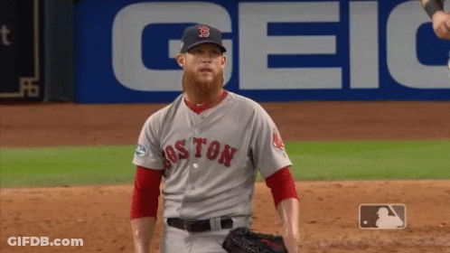 A Baseball Player For The Boston Red Sox Stands In Front Of A Geico Sign GIF