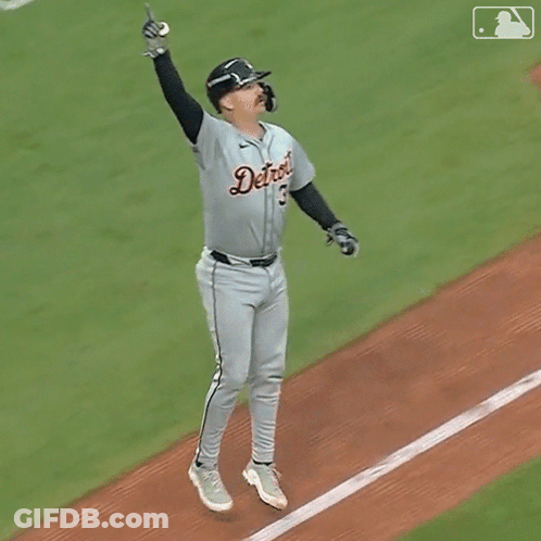 A Baseball Player For The Detroit Tigers Is Jumping In The Air With His Arms In The Air GIF
