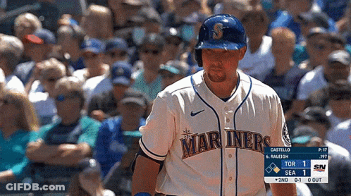 A Baseball Player For The Mariners Stands In Front Of A Crowd Of People GIF
