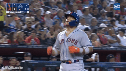 A Baseball Player For The New York Mets Is Running Towards The Fence GIF