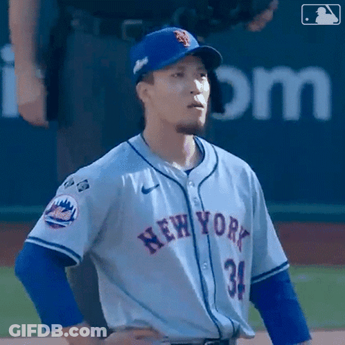 A Baseball Player For The New York Mets Stands On The Field With His Hands On His Hips GIF