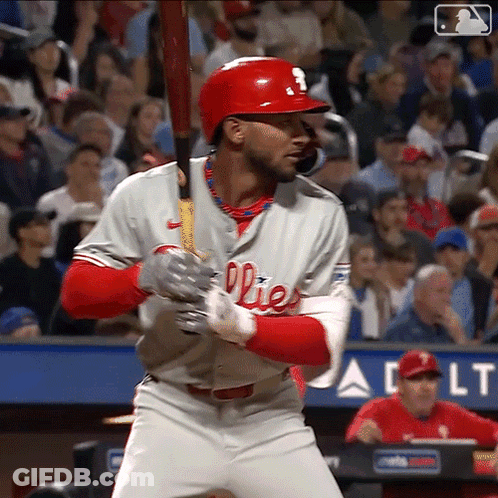 A Baseball Player For The Phillies Is Getting Ready To Swing His Bat GIF