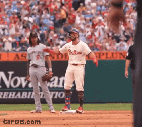 A Baseball Player For The Phillies Is Standing On Base GIF
