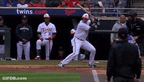 A Baseball Player For The Twins Is About To Swing At A Pitch GIF
