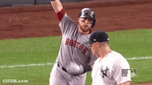 A Baseball Player From The Boston Red Sox Is Standing Next To A Yankees Player On The Field . GIF