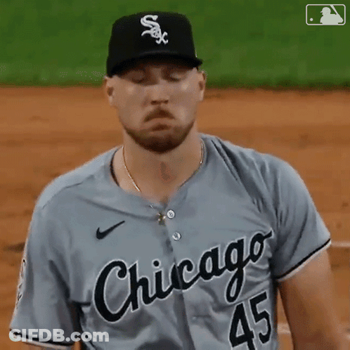 A Baseball Player From The Chicago White Sox Is Standing On The Field With His Eyes Closed GIF