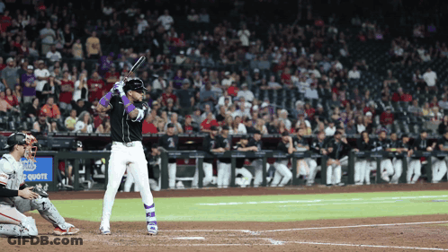 A Baseball Player Getting Ready To Hit The Ball In Front Of A Sign That Says Chase GIF