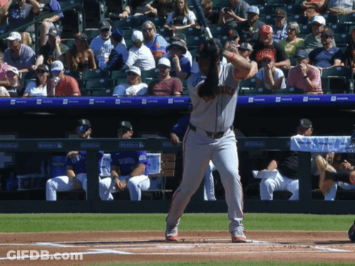 A Baseball Player Getting Ready To Hit The Ball With The Word Giants On His Shirt GIF