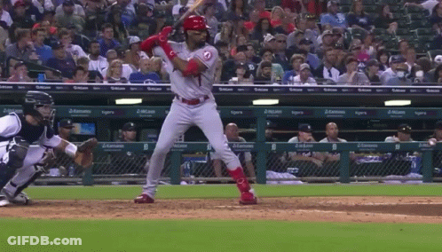 A Baseball Player Getting Ready To Swing At A Ball With A Tigers Logo On The Dugout GIF