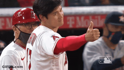 A Baseball Player Giving A Thumbs Up In Front Of A T Mobile Banner GIF