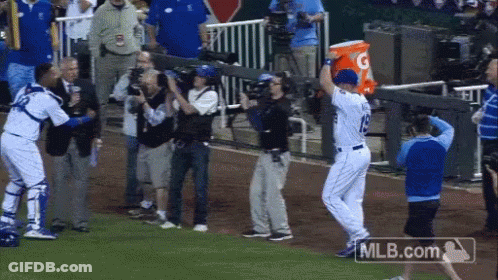 A Baseball Player Holding A Gatorade Bucket In His Hand GIF