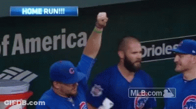 A Baseball Player Holds Up His Fist In The Air In Front Of A Bank Of America Sign GIF