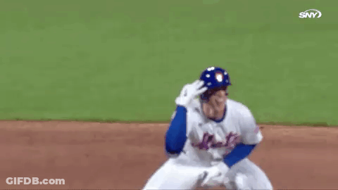 A Baseball Player In A Blue Helmet Is Kneeling On The Field And Waving . GIF
