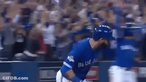 A Baseball Player In A Blue Uniform Is Hugging Another Player On A Baseball Field . GIF