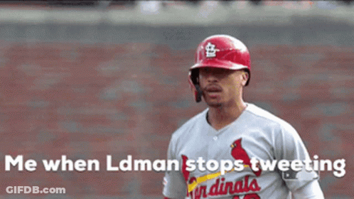 A Baseball Player In A Cardinals Uniform Is Celebrating GIF