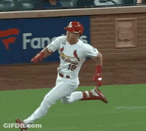 A Baseball Player In A Cardinals Uniform Is Running On A Field . GIF
