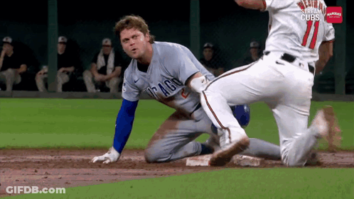 A Baseball Player In A Chicago Cubs Uniform Is Sliding Into Base GIF