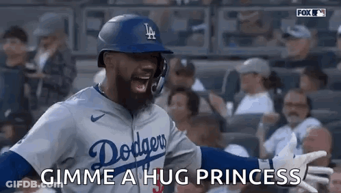 A Baseball Player In A Dodgers Uniform Is Giving A Hug To A Fan . GIF