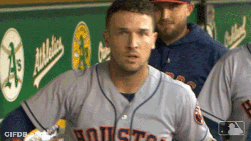 A Baseball Player In A Houston Jersey Stands In The Dugout GIF