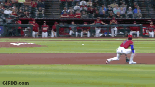 A Baseball Player In A Red And Blue Uniform Runs Towards The Base GIF