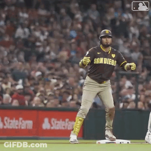A Baseball Player In A San Diego Uniform Is Standing On The Base . GIF
