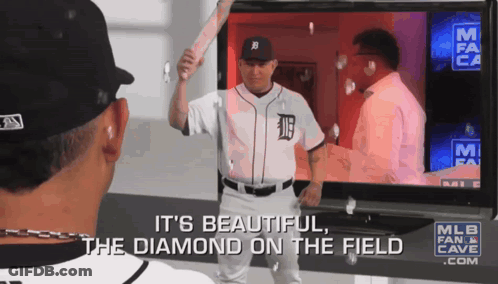 A Baseball Player In A Tigers Jersey Is Holding A Bat In Front Of A Tv Screen GIF