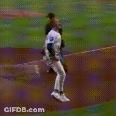 A Baseball Player In A White Jersey Is Running On The Field GIF
