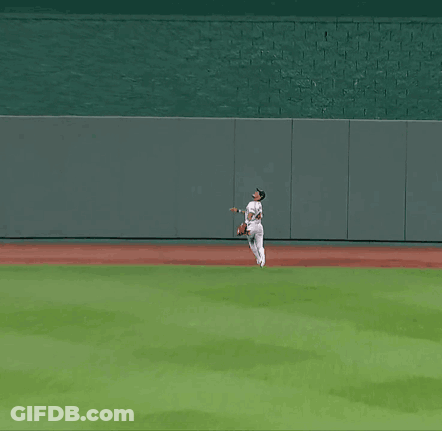 A Baseball Player In A White Uniform Is Running On A Baseball Field GIF
