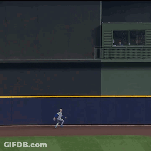 A Baseball Player In A White Uniform Is Running Towards A Base GIF