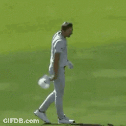 A Baseball Player In A White Uniform Is Standing On A Field . GIF