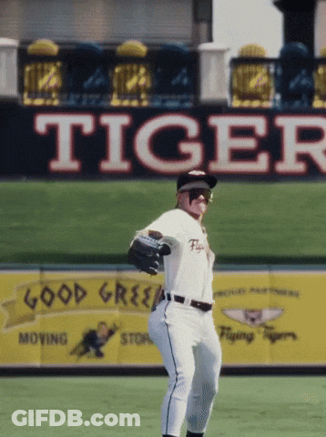 A Baseball Player In Front Of A Large Tiger Sign GIF