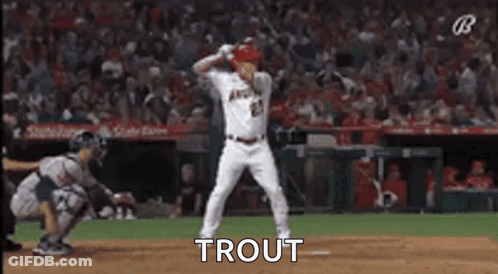 A Baseball Player Is Dancing On The Field During A Game While A Catcher Watches . GIF