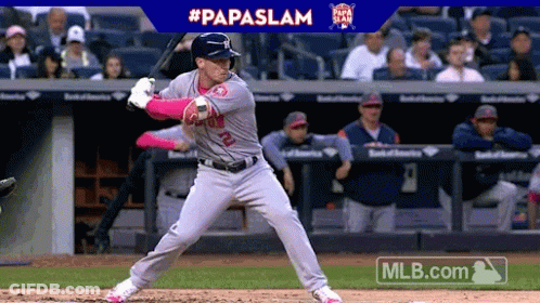 A Baseball Player Is Getting Ready To Swing At A Ball With A Papaslam Advertisement Behind Him GIF