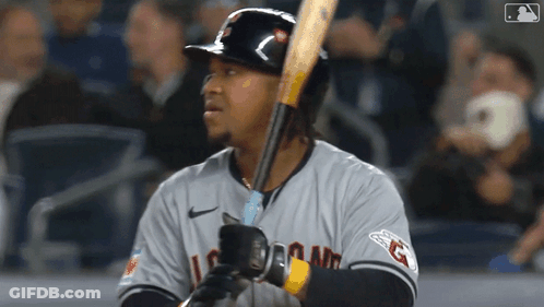 A Baseball Player Is Holding A Bat And Wearing A Jersey That Says Indians GIF