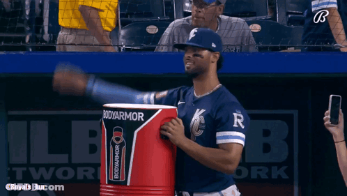 A Baseball Player Is Holding A Bodyarmor Cooler GIF